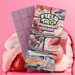 Field Trip Strawberry Cream magic mushroom chocolate bar with opened squares and strawberries in background