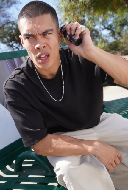 Person holding cannabis containers with eyes.