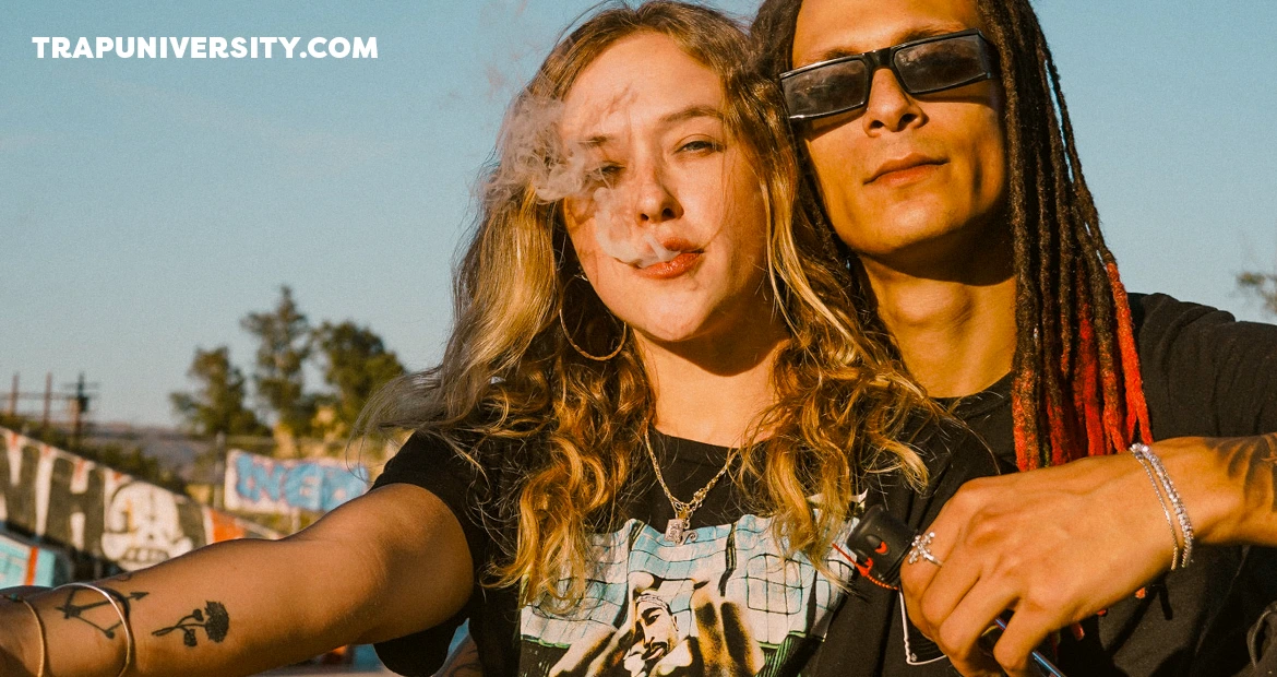 Two friends enjoying a calm moment outdoors with smoke in the air representing relaxing the right way